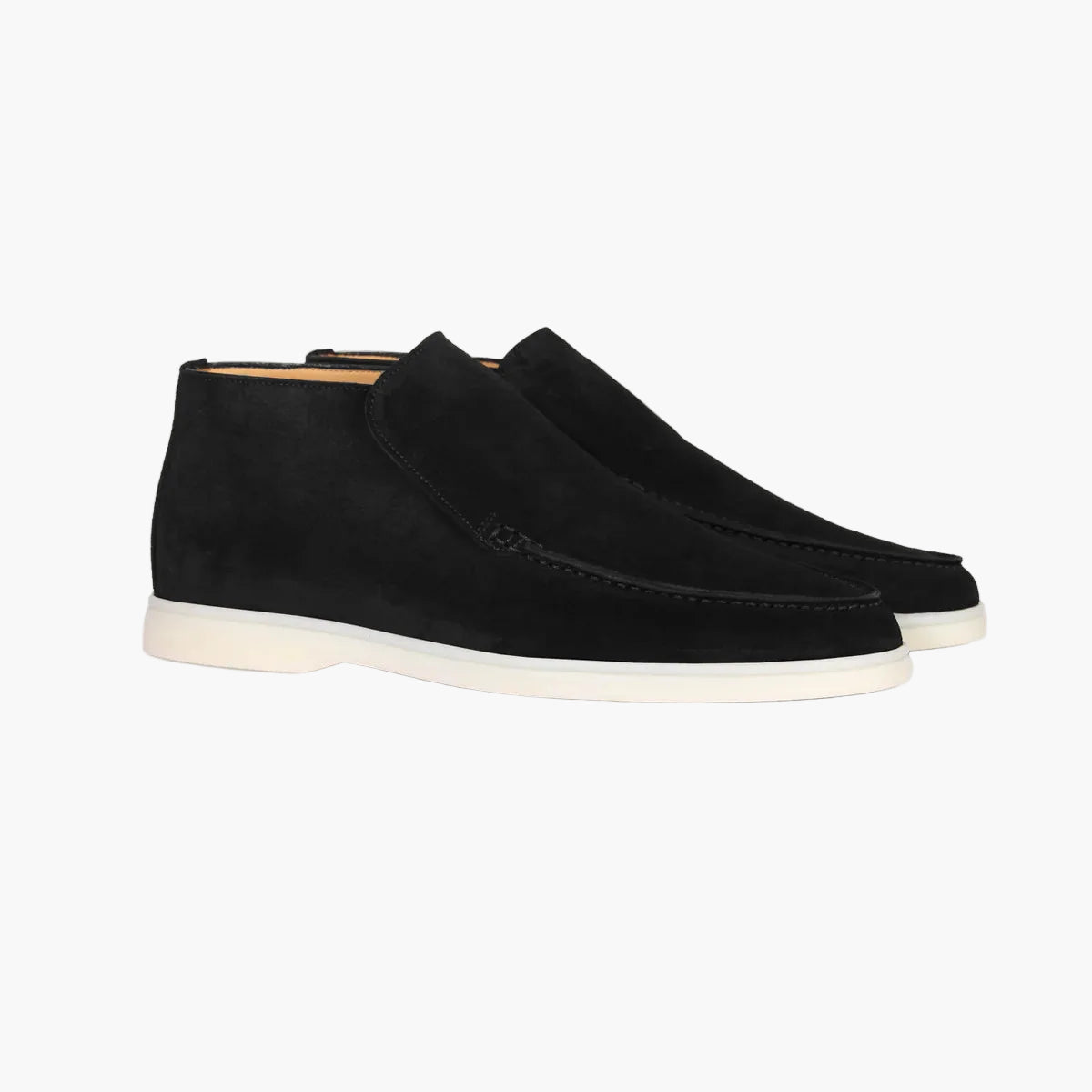 Black suede shoes on a light gray background
