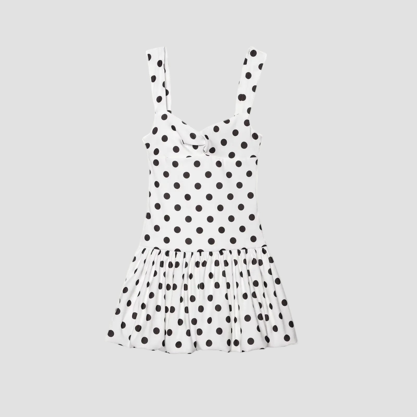 White dress with black polka dots on a white background