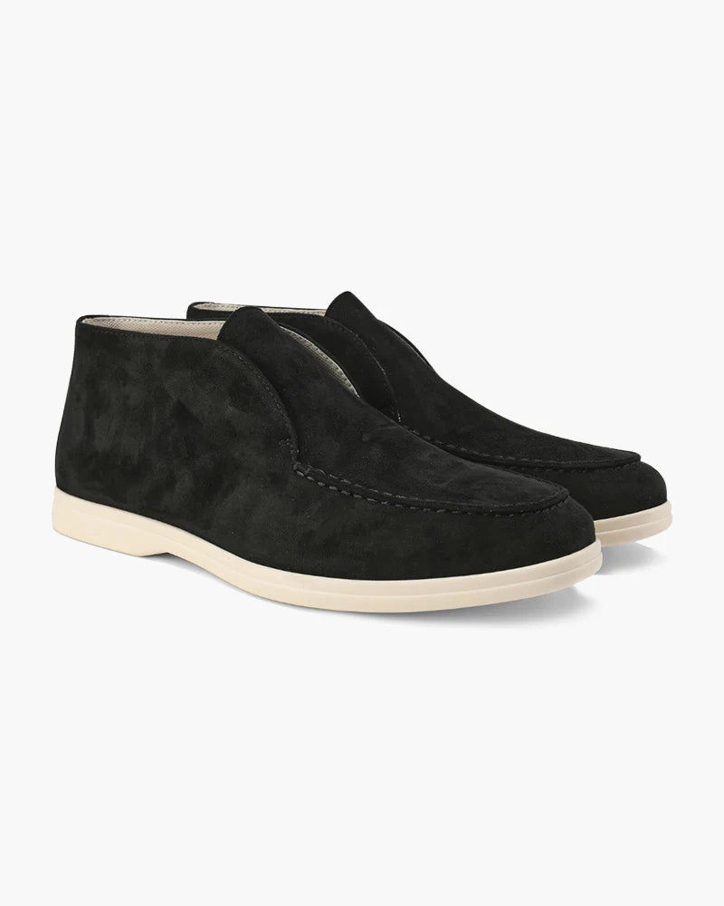 Pair of black suede loafers on a white background