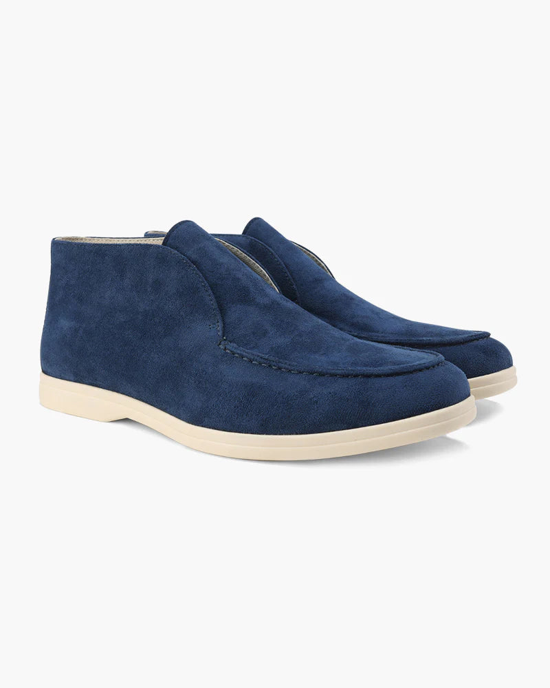 Pair of blue suede shoes on a white background