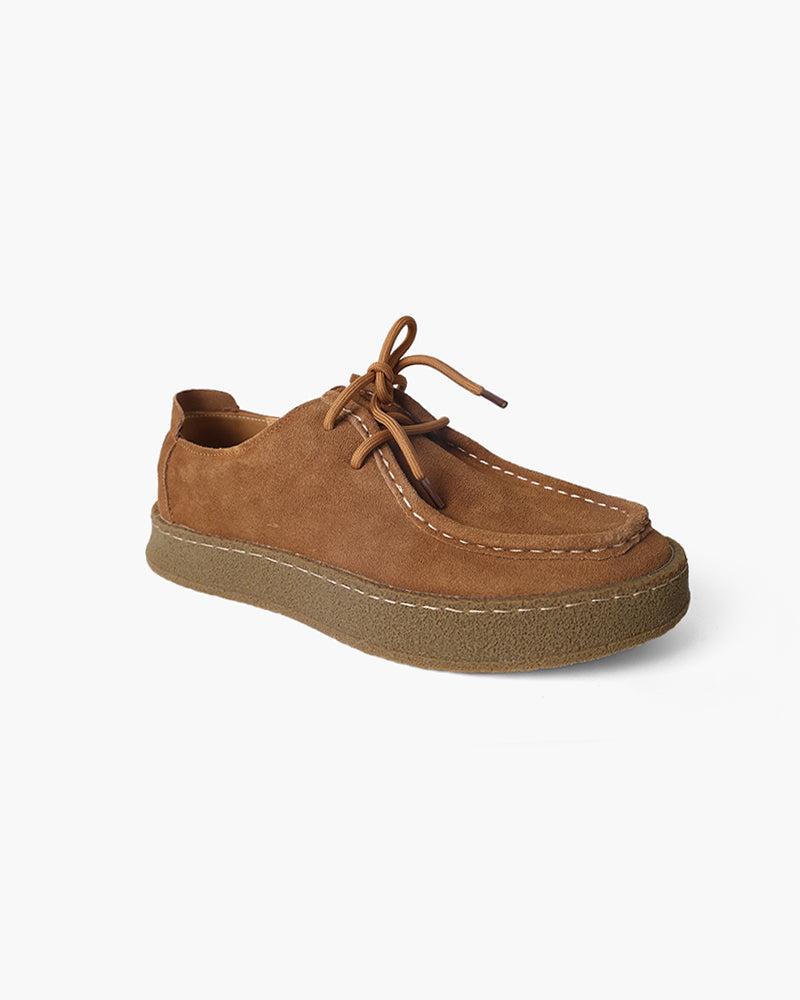 Brown suede shoe on a white background
