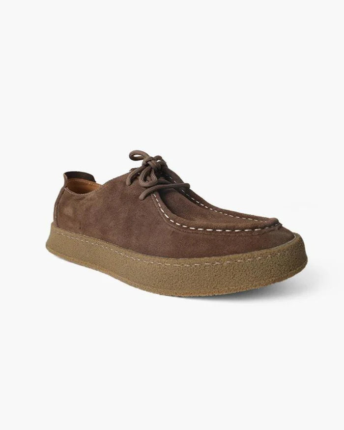 Brown suede shoe on a white background