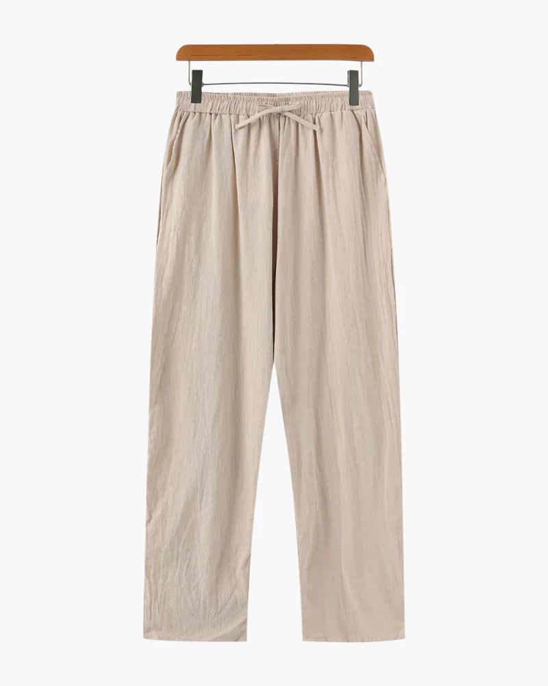 Beige pants on a hanger against a white background
