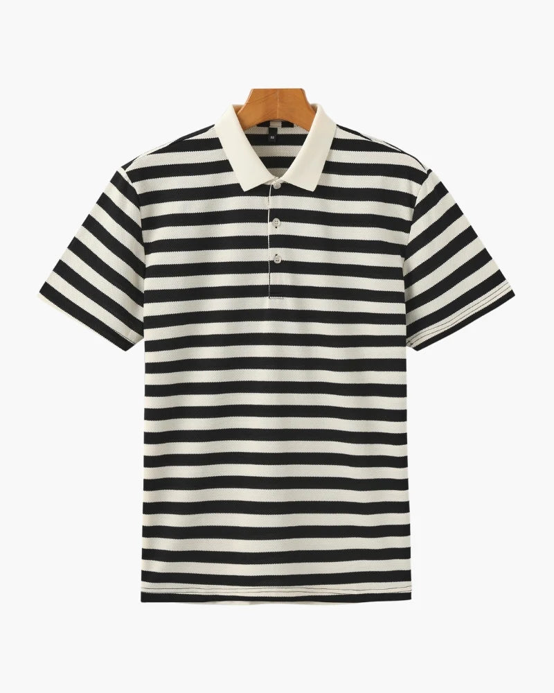 Black and white striped polo shirt on a hanger against a white background