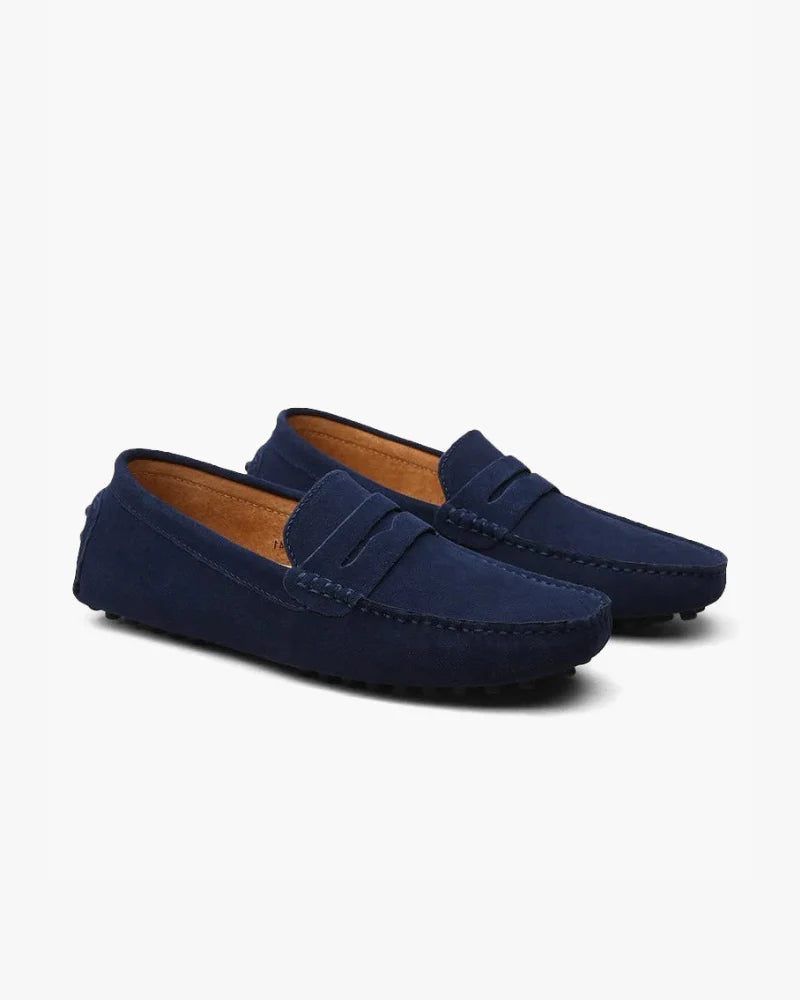 Pair of blue loafers on a white background