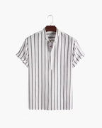 Striped shirt on a hanger against a white background