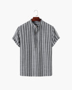 Striped shirt on a hanger against a white background