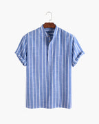 Blue and white striped shirt on a hanger against a white background