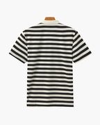 Black and white striped polo shirt on a mannequin against a white background