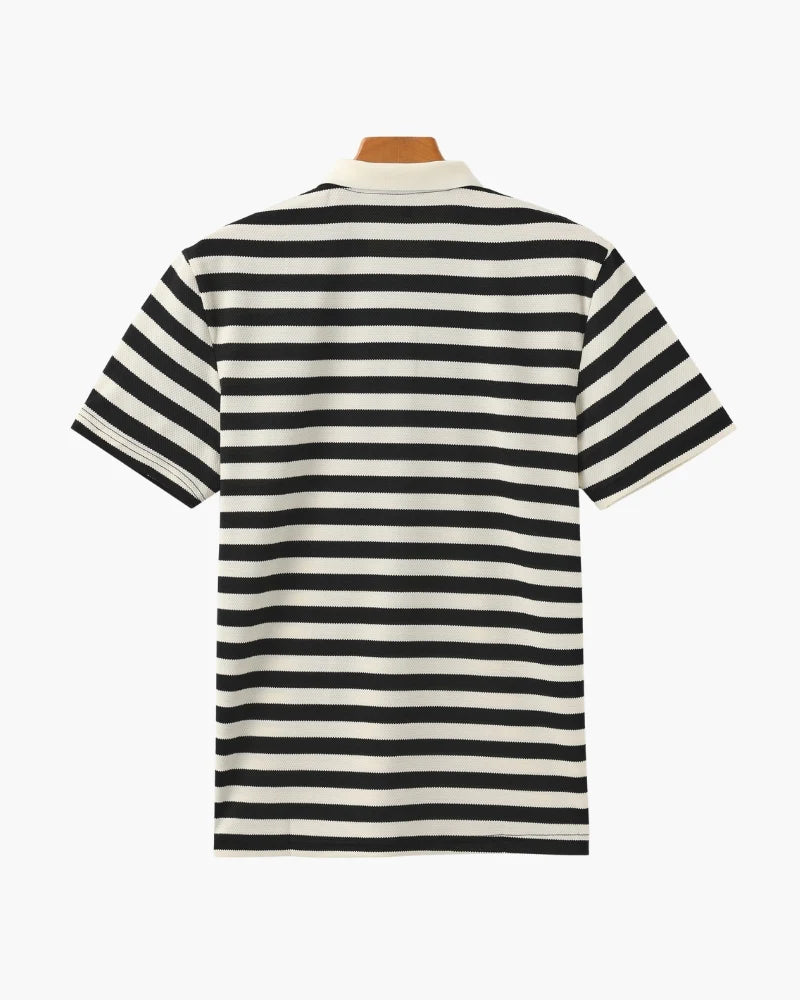 Black and white striped polo shirt on a mannequin against a white background