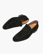Close-up of the iconic penny keeper strap on the Altivieri suede loafers.