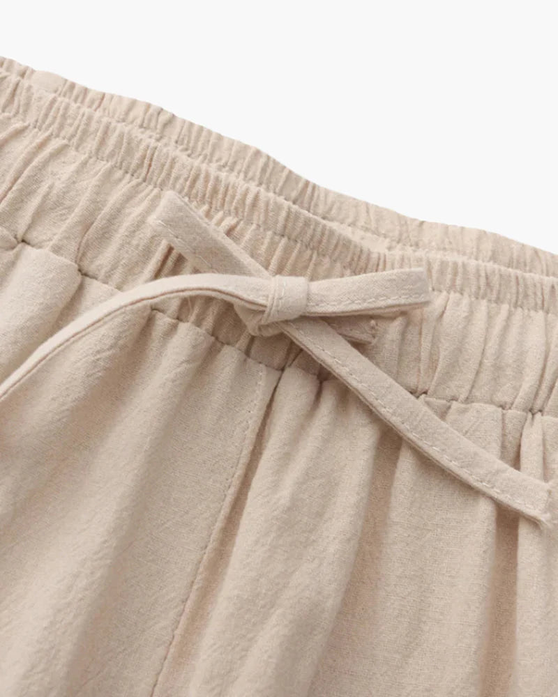 Close-up of beige pants with an elastic waistband on a white background