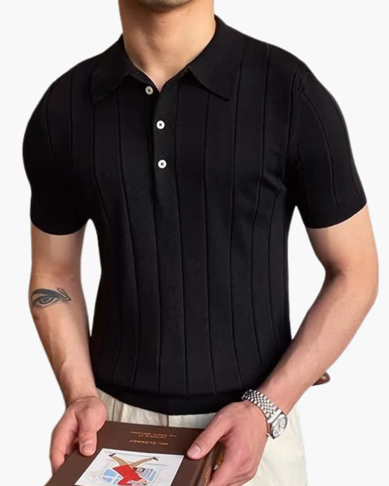 Man wearing the Cannes ribbed polo with white trousers at a seaside resort.