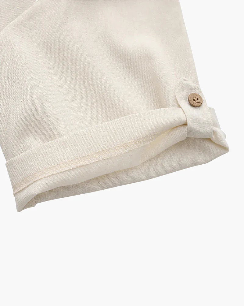 Close-up of a beige fabric with a button on a white background