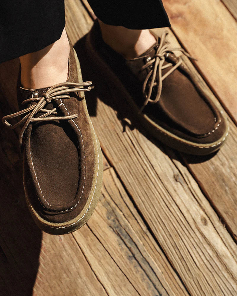 Brown leather shoes on a wooden floor