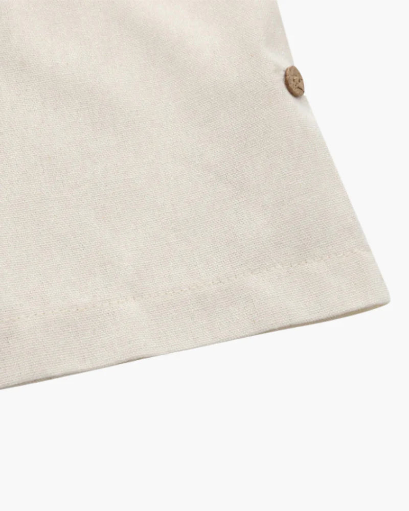 Close-up of a beige fabric with a button on a white background