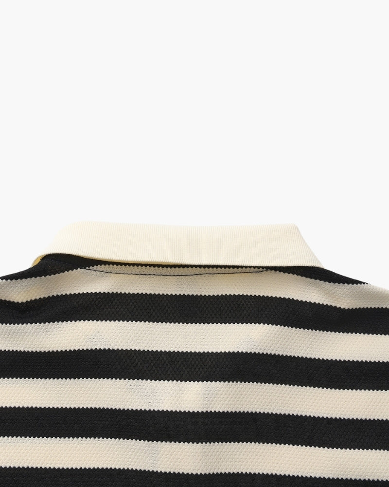 Close-up of a black and white striped shirt on a mannequin with a white background