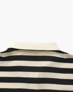 Close-up of a black and white striped shirt on a mannequin with a white background