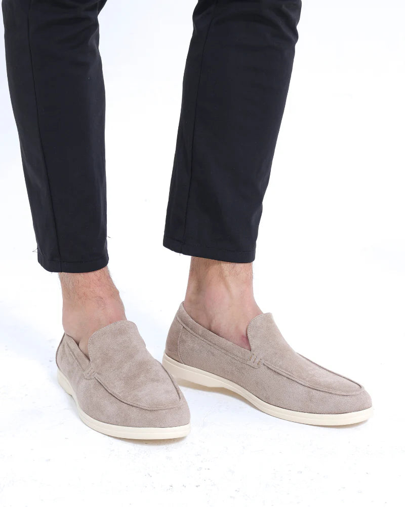Man wearing suede loafers with trousers.