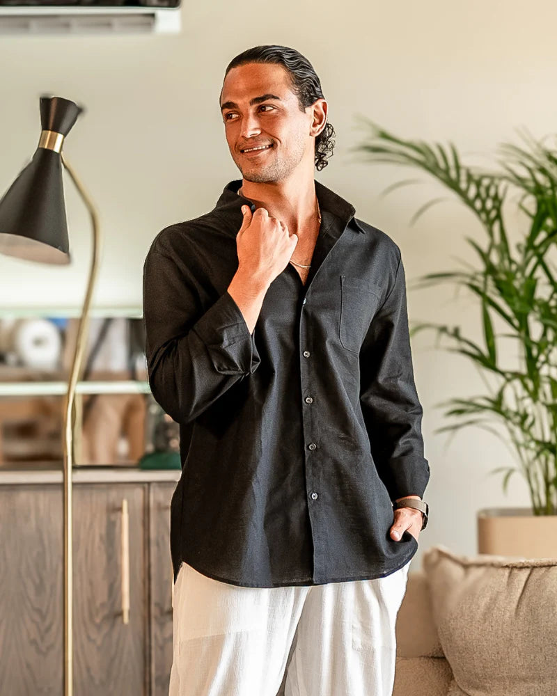 Man wearing a black shirt in a living room setting