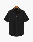 Black short-sleeve shirt on a hanger against a white background