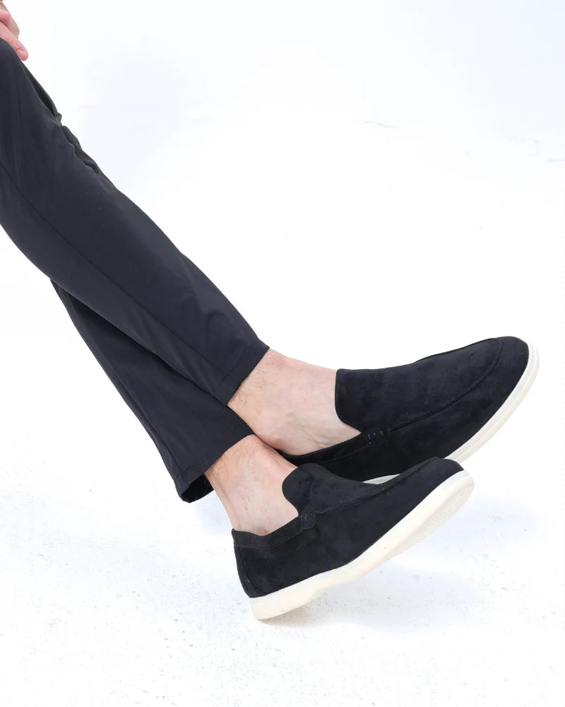 Man wearing suede loafers with trousers.