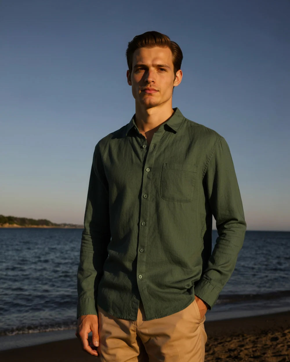Man standing on a beach with ocean and sky in the background