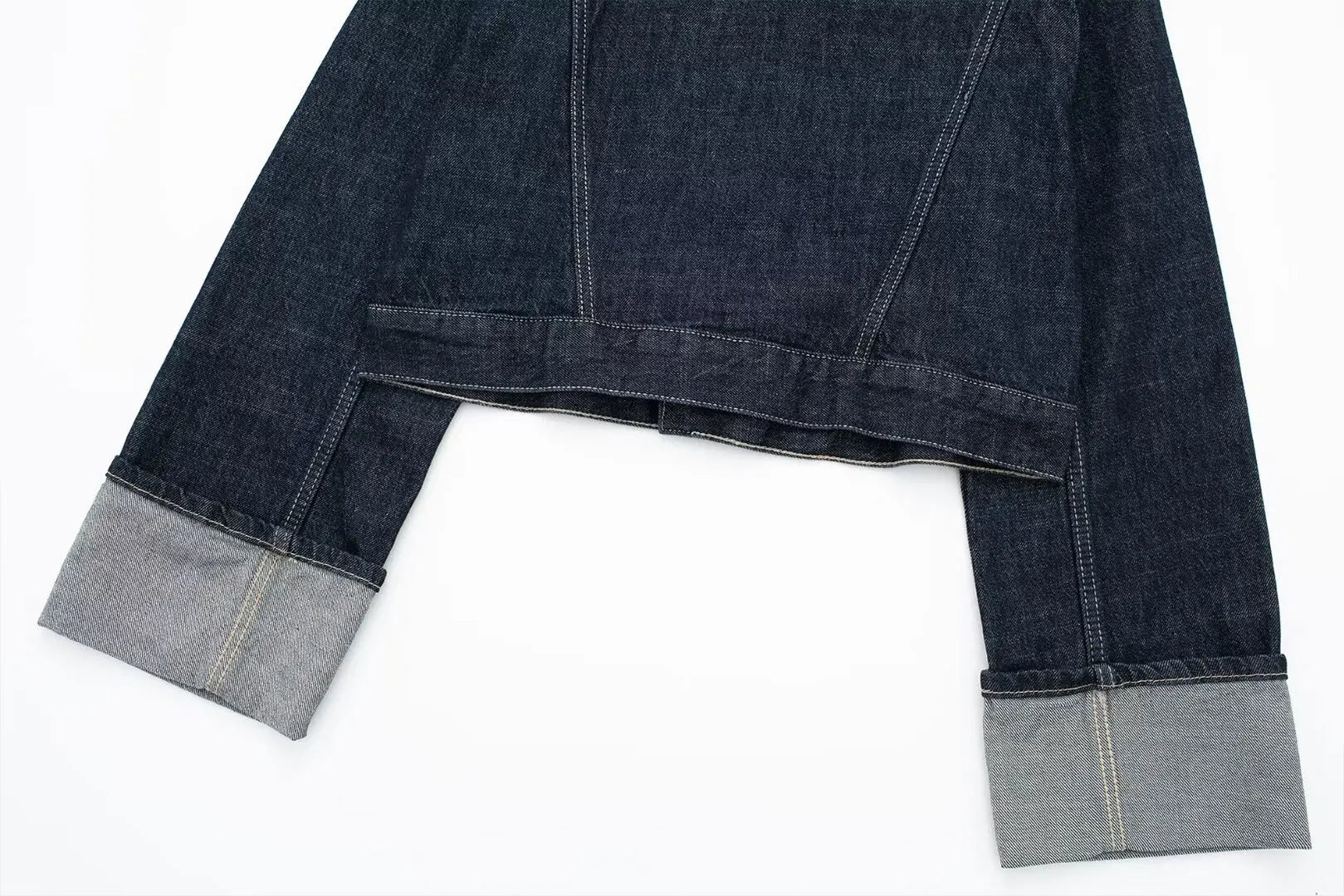 Dark blue denim jacket with gray cuffs on a white background