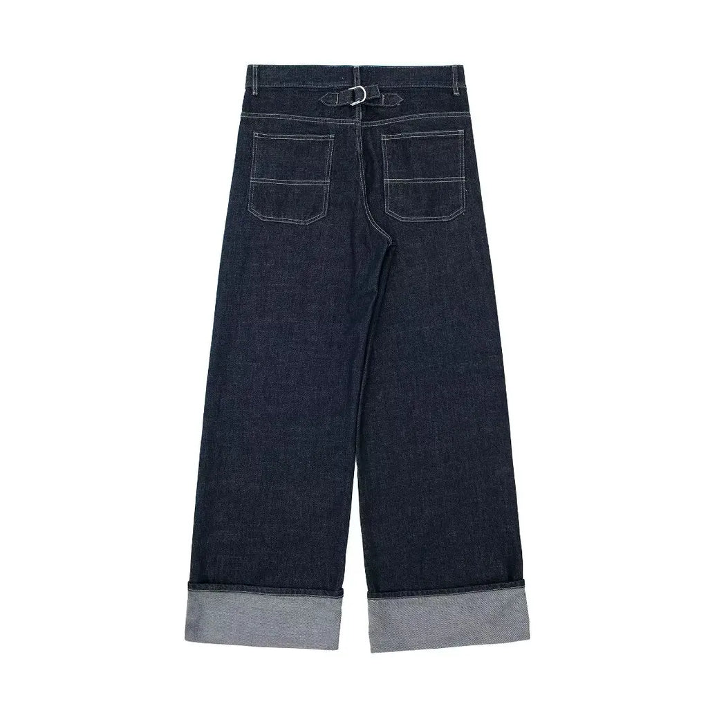 Dark blue jeans with rolled-up cuffs on a white background