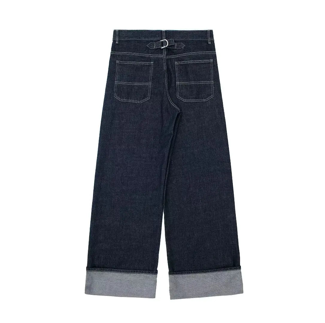 Dark blue jeans with rolled-up cuffs on a white background