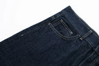 Close-up of dark blue jeans on a white background