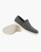 Gray loafers with white soles on a white background