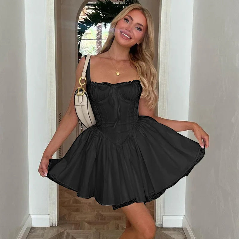 Woman wearing a black dress standing in a doorway.