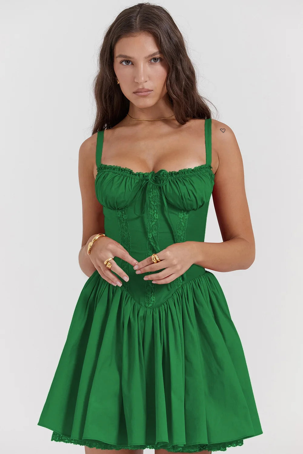 Woman wearing a green dress against a white background