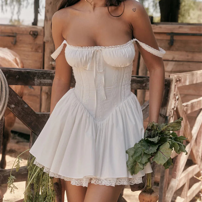 Woman in a white dress holding vegetables in a rustic outdoor setting