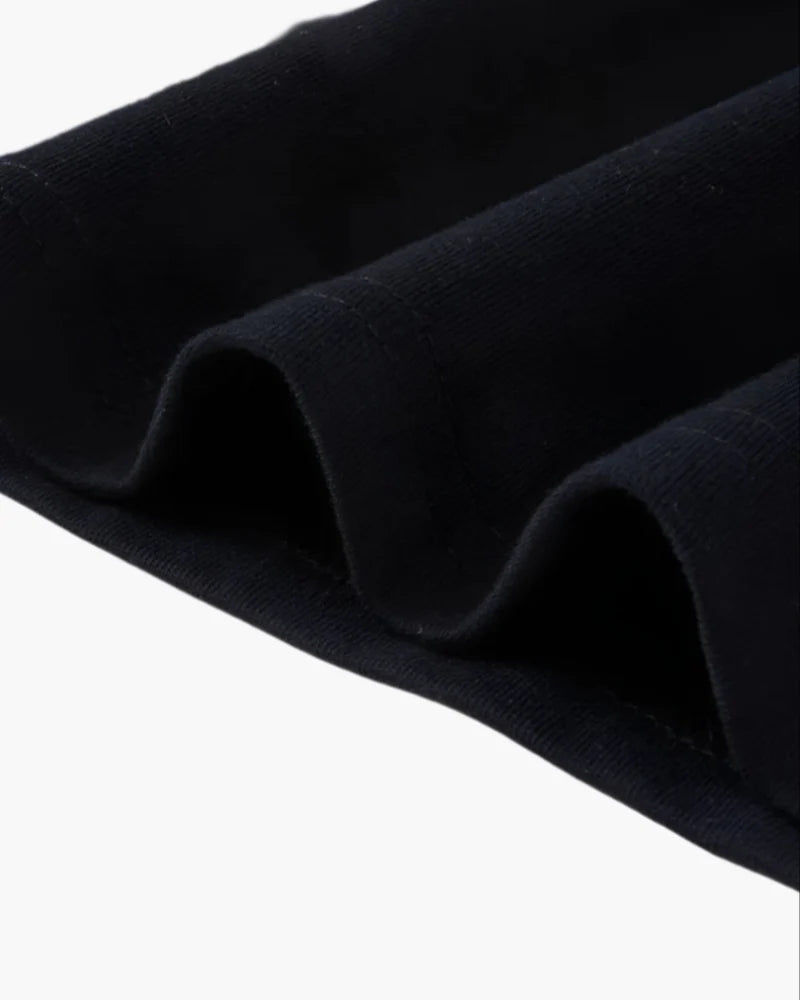 Close-up of dark blue fabric with folds on a white background