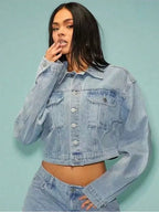 Woman wearing a light blue denim jacket against a light blue background