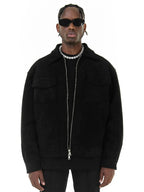 Man wearing a black jacket and sunglasses on a white background