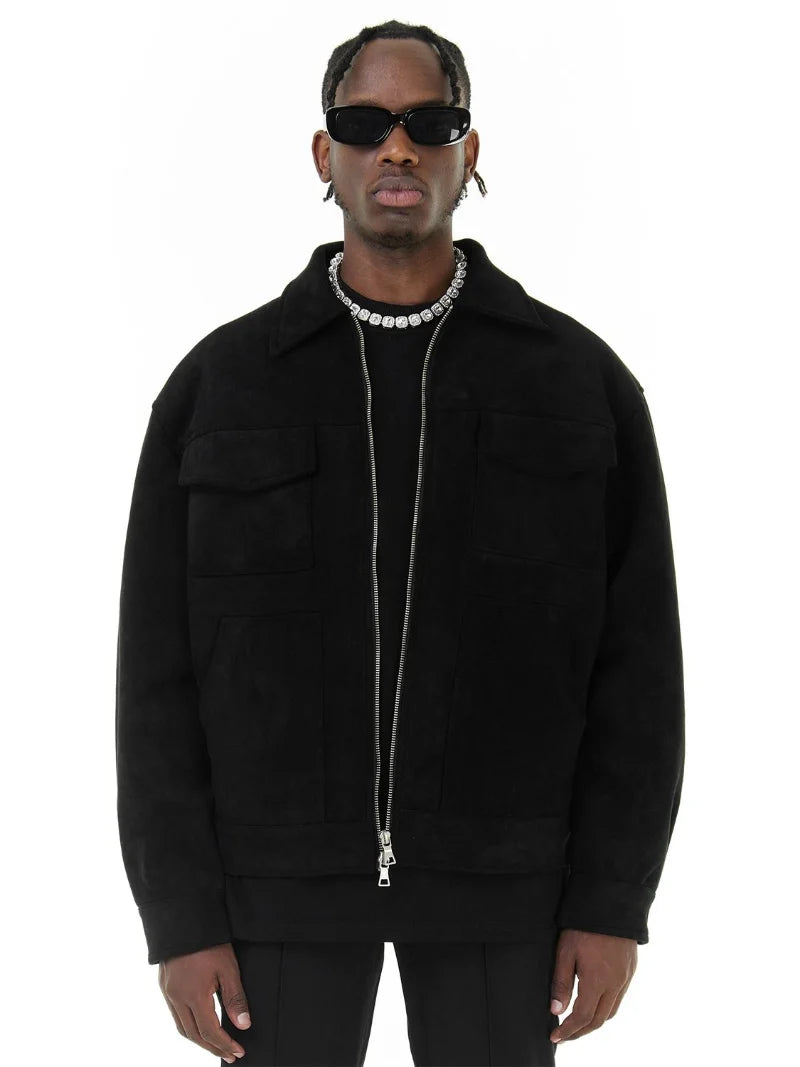 Man wearing a black jacket and sunglasses on a white background