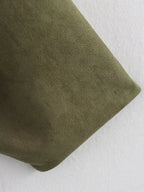 Close-up of a green fabric texture on a white background