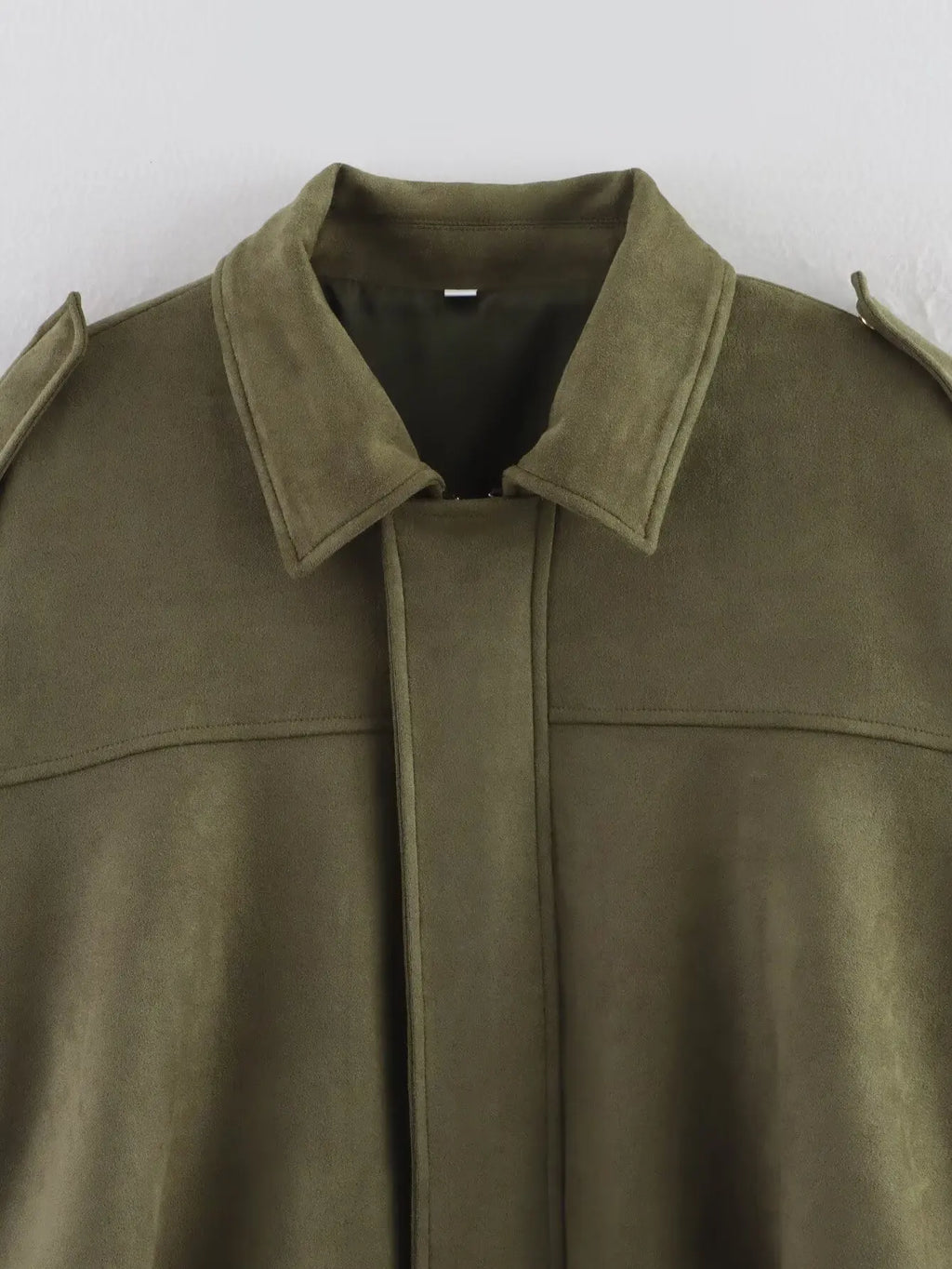 Green suede jacket with a plain background
