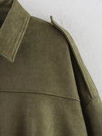 Close-up of a green coat with a white background