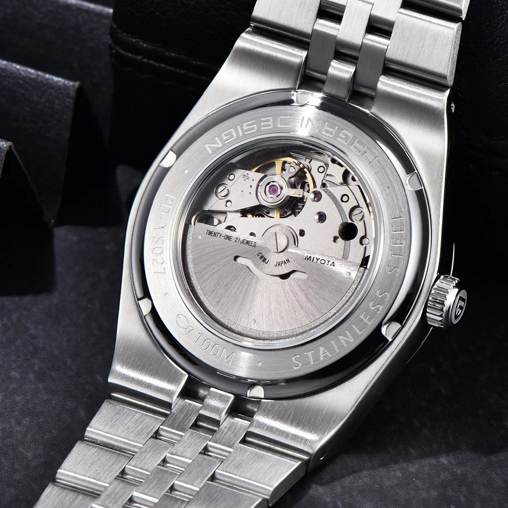 Close-up of a silver watch with visible brand name on a dark background
