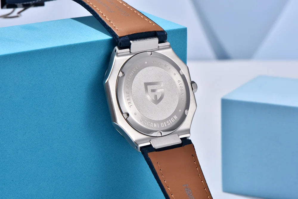 Silver watch with brown leather strap on a blue geometric background