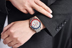 Close-up of a person wearing a watch with a red, white, and blue face on a dark suit.