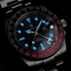 Luxury watch with black face and red bezel on a dark background