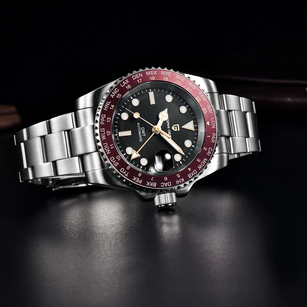 Watch with a silver band and red and black dial on a dark background