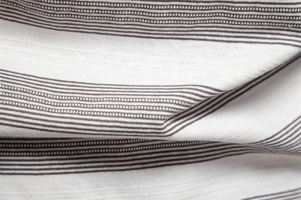 Close-up of striped fabric with black and white lines on a white background
