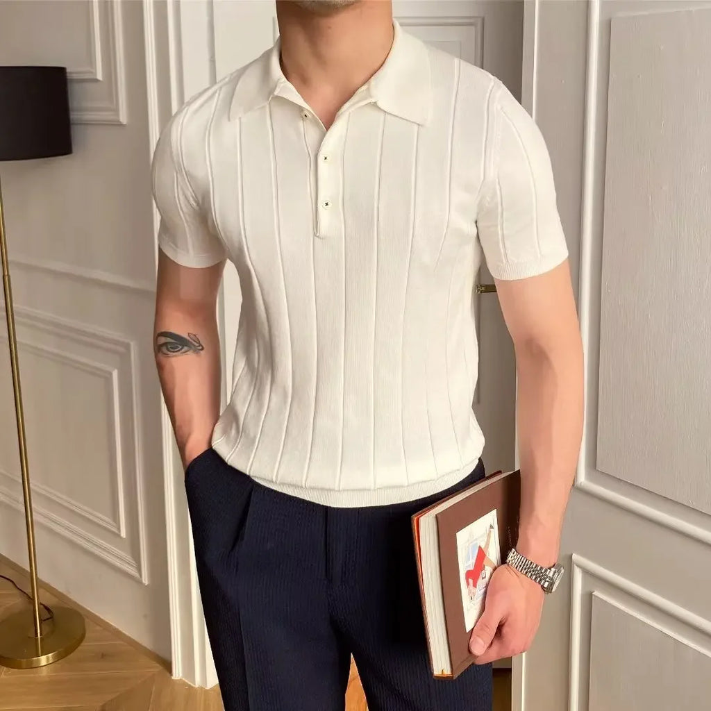 Man wearing the Cannes ribbed polo with white trousers at a seaside resort.