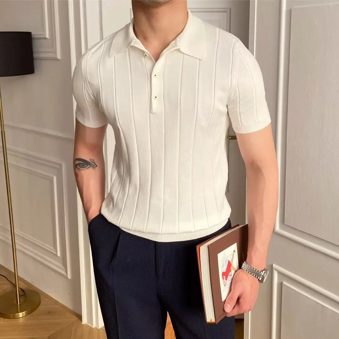Man wearing the Cannes ribbed polo with white trousers at a seaside resort.